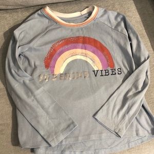 Sunshine Vibes- Blue-gray long sleeve shirt with pink hues rainbow.
